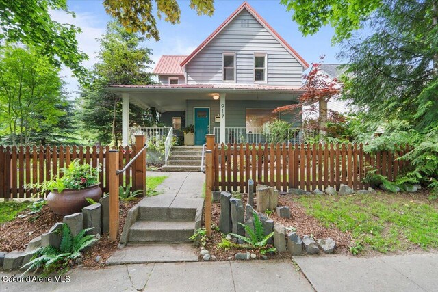 917 E Young Ave, Coeur Dalene, ID 83814 - view of front of house featuring covered porch, fence, and metal roof