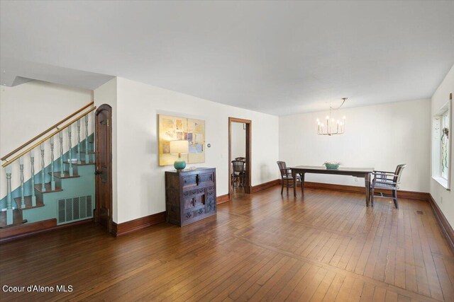 917 E Young Ave, Coeur Dalene, ID 83814 - dining area featuring hardwood / wood-style floors, a chandelier, stairs, and baseboards