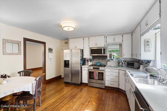 917 E Young Ave, Coeur Dalene, ID 83814 - kitchen featuring appliances with stainless steel finishes, a sink, light countertops, dark wood-type flooring, and white cabinetry