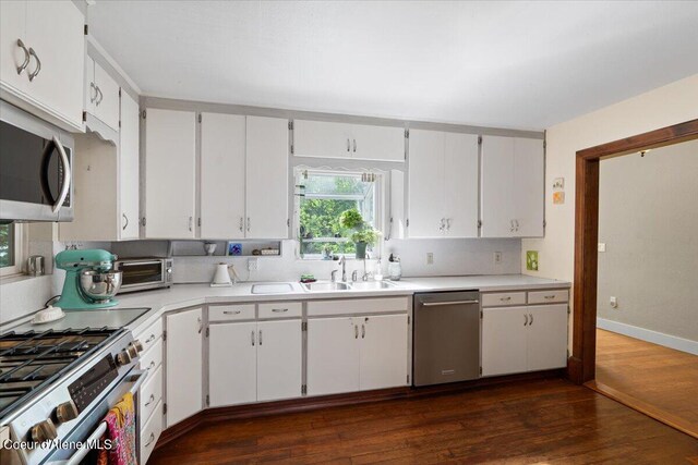 917 E Young Ave, Coeur Dalene, ID 83814 - kitchen featuring appliances with stainless steel finishes, light countertops, a sink, dark wood-style floors, and white cabinetry