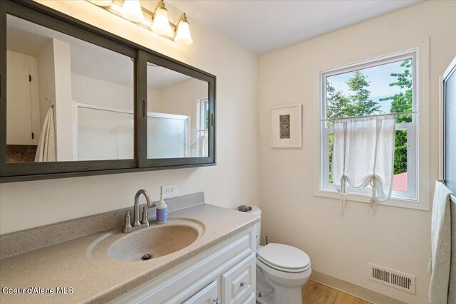 917 E Young Ave, Coeur Dalene, ID 83814 - bathroom featuring vanity, toilet, and wood finished floors