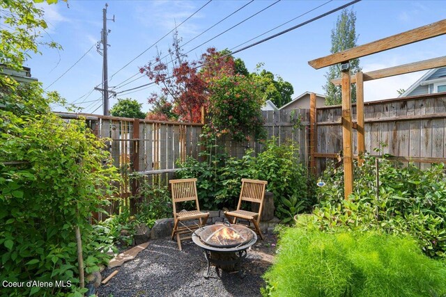 917 E Young Ave, Coeur Dalene, ID 83814 - view of patio / terrace featuring a fire pit and fence
