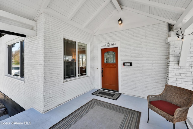 property entrance featuring brick siding