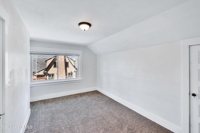 additional living space with carpet, lofted ceiling, and baseboards