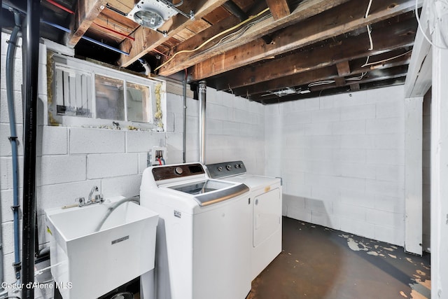 laundry area with a sink, independent washer and dryer, and laundry area