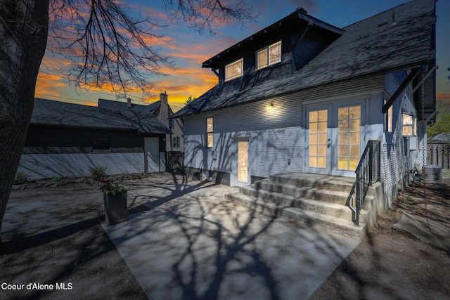 rear view of property featuring french doors, a patio area, and central AC unit