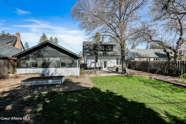 back of property featuring a yard, a patio, and fence