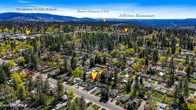 aerial view with a wooded view and a mountain view