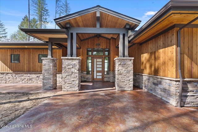 doorway to property featuring french doors and stone siding