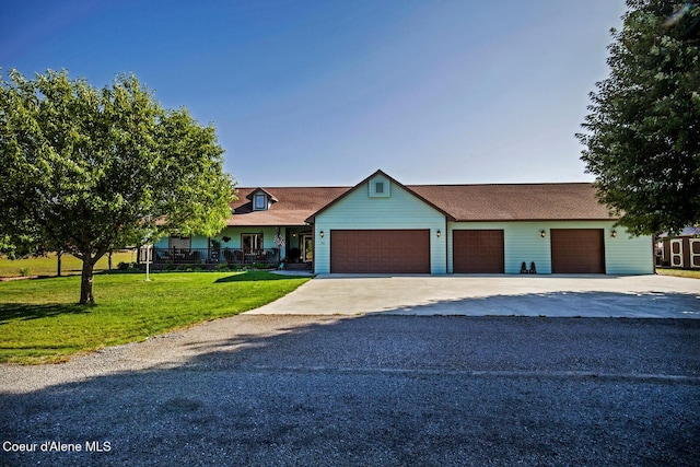 ranch-style house with concrete driveway, a front lawn, and a garage