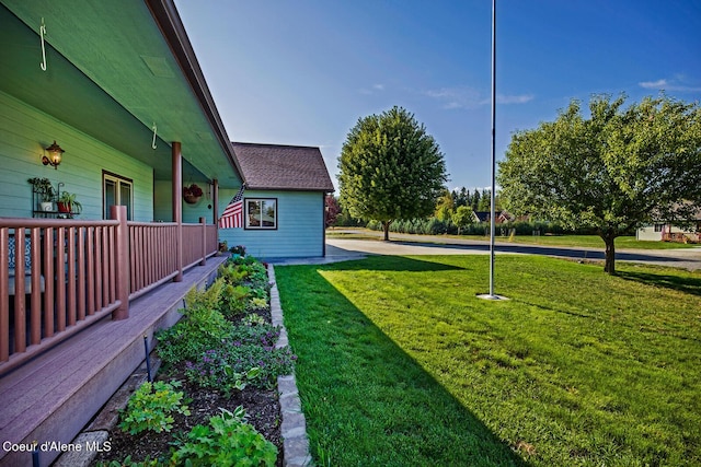 view of yard featuring covered porch