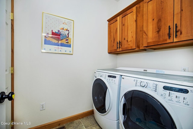 washroom featuring cabinet space, independent washer and dryer, and baseboards