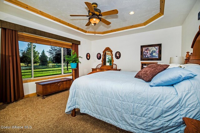 bedroom featuring crown molding, ceiling fan, a tray ceiling, carpet flooring, and recessed lighting