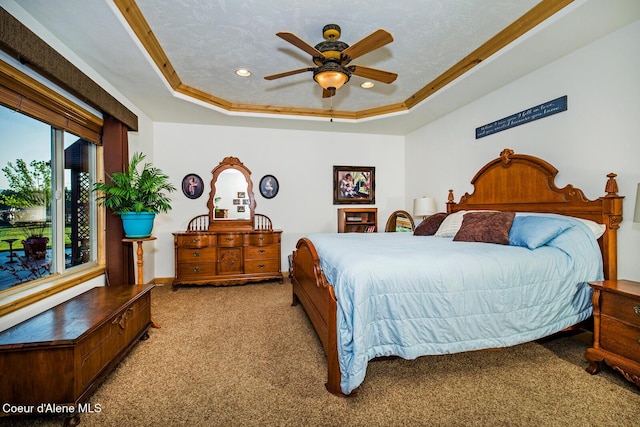 carpeted bedroom featuring a tray ceiling, a ceiling fan, ornamental molding, and recessed lighting