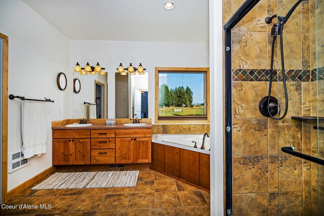 full bathroom featuring a bath, a shower stall, double vanity, and a sink
