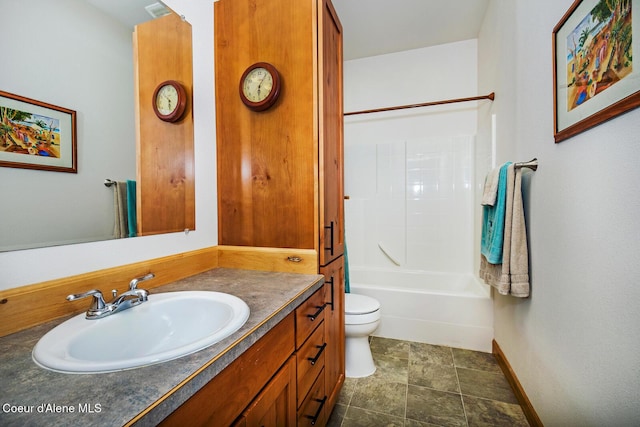 full bathroom with baseboards, toilet, vanity, and shower / washtub combination