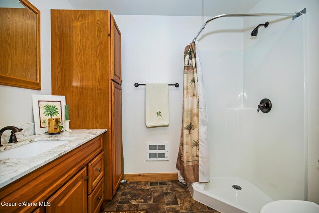 bathroom featuring a shower stall, stone finish flooring, heating unit, and visible vents