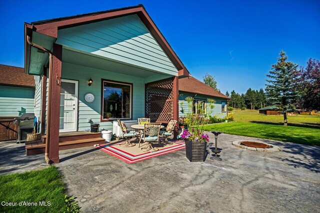back of property featuring a patio area, a lawn, and outdoor dining area
