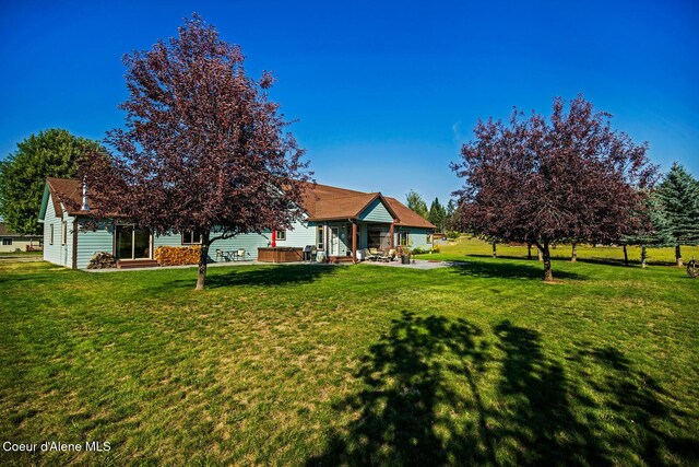 back of house featuring a gazebo, a patio area, and a lawn