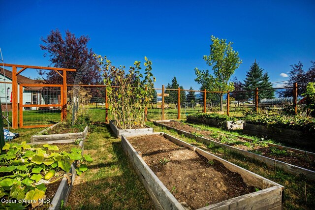 view of yard with fence and a vegetable garden