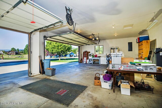 garage featuring electric panel and a garage door opener