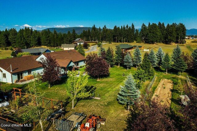 aerial view featuring a wooded view and a mountain view
