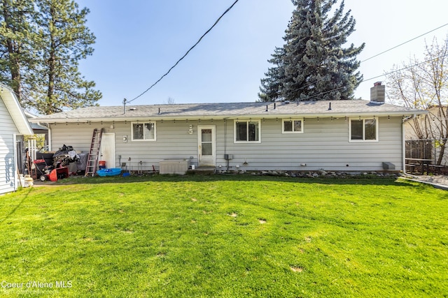 501 E 18th Ave, Post Falls, ID 83854 - rear view of property featuring a yard and a chimney
