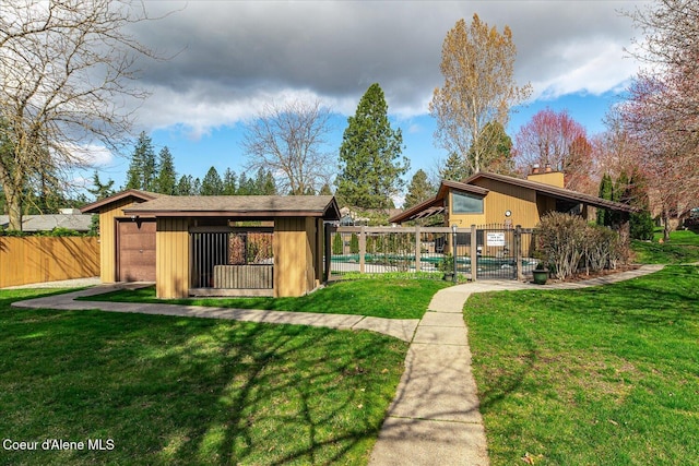 exterior space with fence, a swimming pool, and a lawn