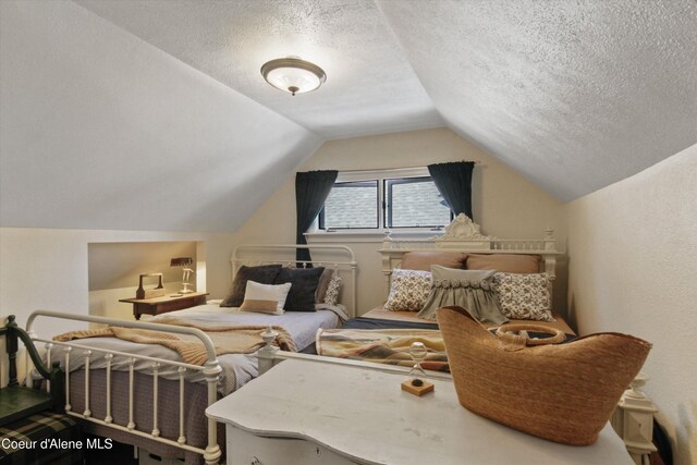 419 N Park Dr, Coeur Dalene, ID 83814 - bedroom with lofted ceiling and a textured ceiling