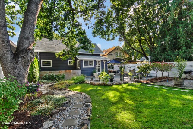 419 N Park Dr, Coeur Dalene, ID 83814 - back of house featuring fence, a yard, a patio, and a shingled roof