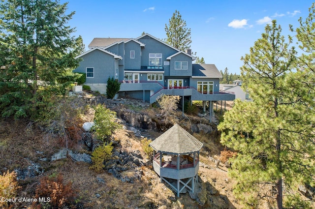 255 S Theresa Terrace Dr, Post Falls, ID 83854 - back of property featuring a gazebo, a wooden deck, stairs, and a chimney