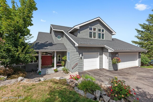 255 S Theresa Terrace Dr, Post Falls, ID 83854 - view of front facade featuring a shingled roof, an attached garage, a porch, and aphalt driveway