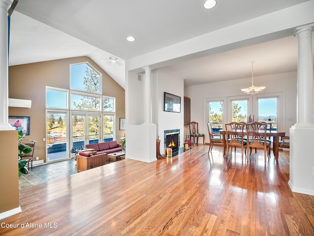 255 S Theresa Terrace Dr, Post Falls, ID 83854 - dining area with a lit fireplace, decorative columns, recessed lighting, and wood finished floors