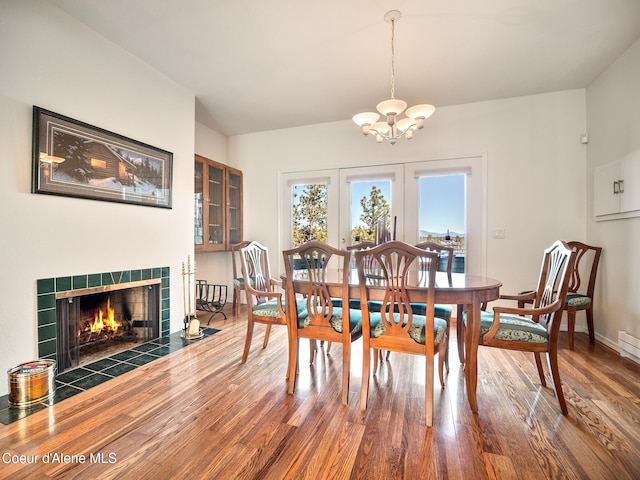 255 S Theresa Terrace Dr, Post Falls, ID 83854 - dining space featuring an inviting chandelier, baseboards, wood finished floors, and a fireplace