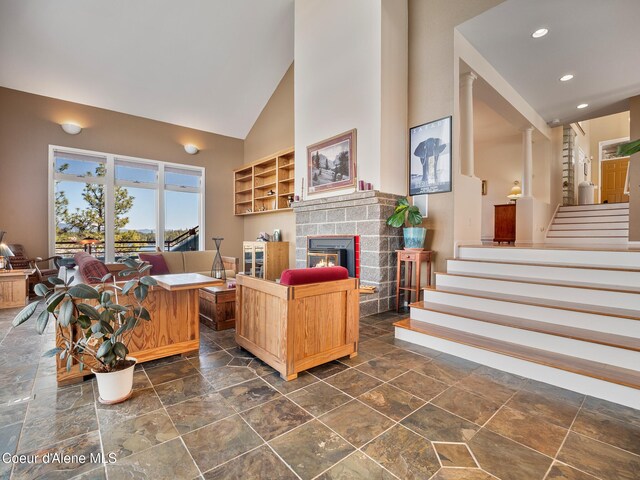 255 S Theresa Terrace Dr, Post Falls, ID 83854 - living room featuring stairway, high vaulted ceiling, a glass covered fireplace, and recessed lighting
