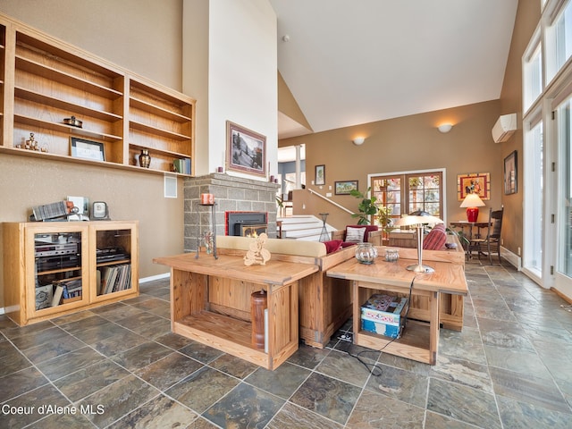 255 S Theresa Terrace Dr, Post Falls, ID 83854 - living area featuring a fireplace, high vaulted ceiling, baseboards, and stone tile flooring