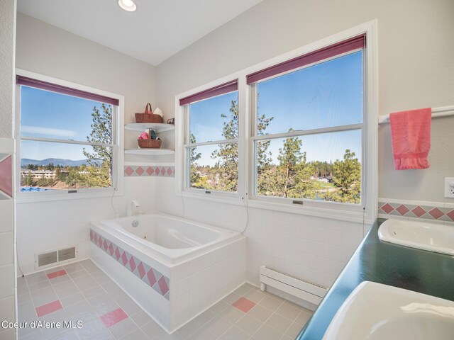 255 S Theresa Terrace Dr, Post Falls, ID 83854 - bathroom with visible vents, tile patterned flooring, tile walls, a bath, and a baseboard heating unit