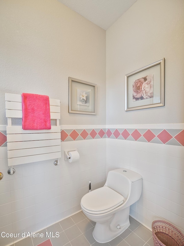 255 S Theresa Terrace Dr, Post Falls, ID 83854 - bathroom with toilet, tile walls, wainscoting, and tile patterned flooring