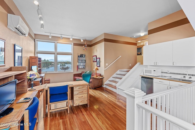 255 S Theresa Terrace Dr, Post Falls, ID 83854 - office space featuring an AC wall unit, a sink, wood finished floors, and track lighting