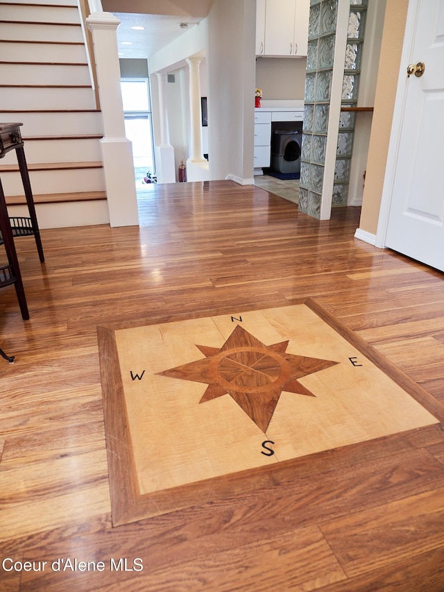 255 S Theresa Terrace Dr, Post Falls, ID 83854 - unfurnished living room featuring decorative columns, stairs, washer / clothes dryer, and wood finished floors