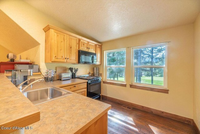 131 Long Dr, Priest Lake, ID 83856 - kitchen with a textured ceiling, a sink, black appliances, light brown cabinetry, and dark wood-type flooring