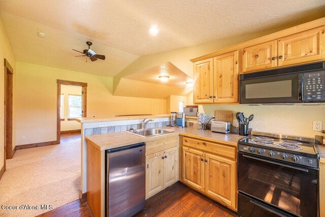 131 Long Dr, Priest Lake, ID 83856 - kitchen with light countertops, black appliances, ceiling fan, a sink, and a peninsula