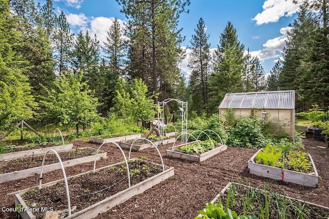 view of yard with an outdoor structure, a garden, and an exterior structure