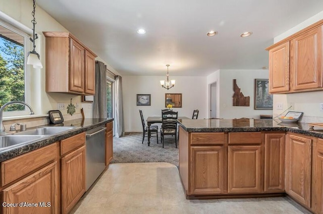 kitchen with a peninsula, hanging light fixtures, a sink, stainless steel dishwasher, and a chandelier