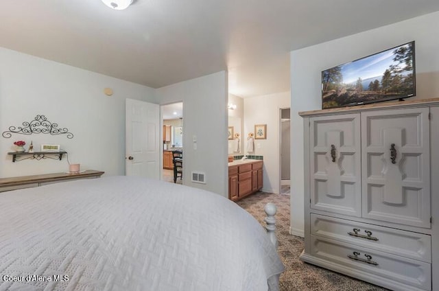 bedroom featuring carpet flooring, ensuite bath, and visible vents