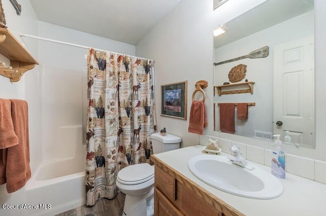 bathroom with toilet, wood finished floors, shower / tub combo, visible vents, and vanity