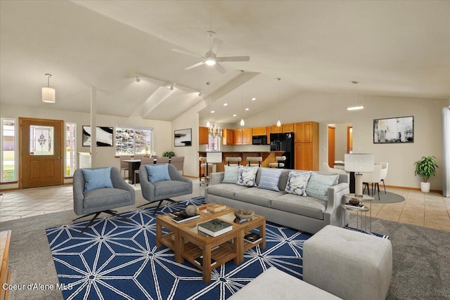 living room featuring vaulted ceiling, plenty of natural light, light tile patterned floors, ceiling fan, and track lighting