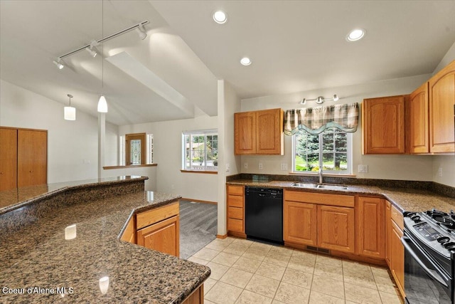kitchen featuring black appliances, a sink, rail lighting, lofted ceiling, and dark stone counters