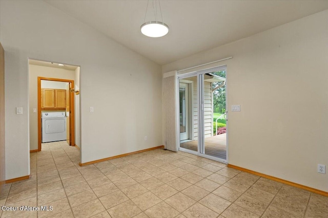 unfurnished room featuring washer / clothes dryer, lofted ceiling, baseboards, and light tile patterned floors