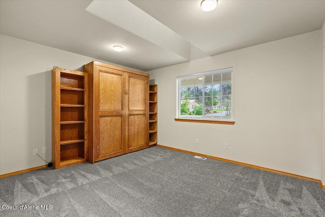 unfurnished bedroom with baseboards and carpet